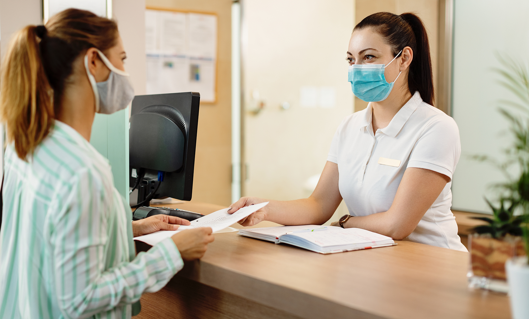 Woman checking in at the front desk of a dental office in Houston