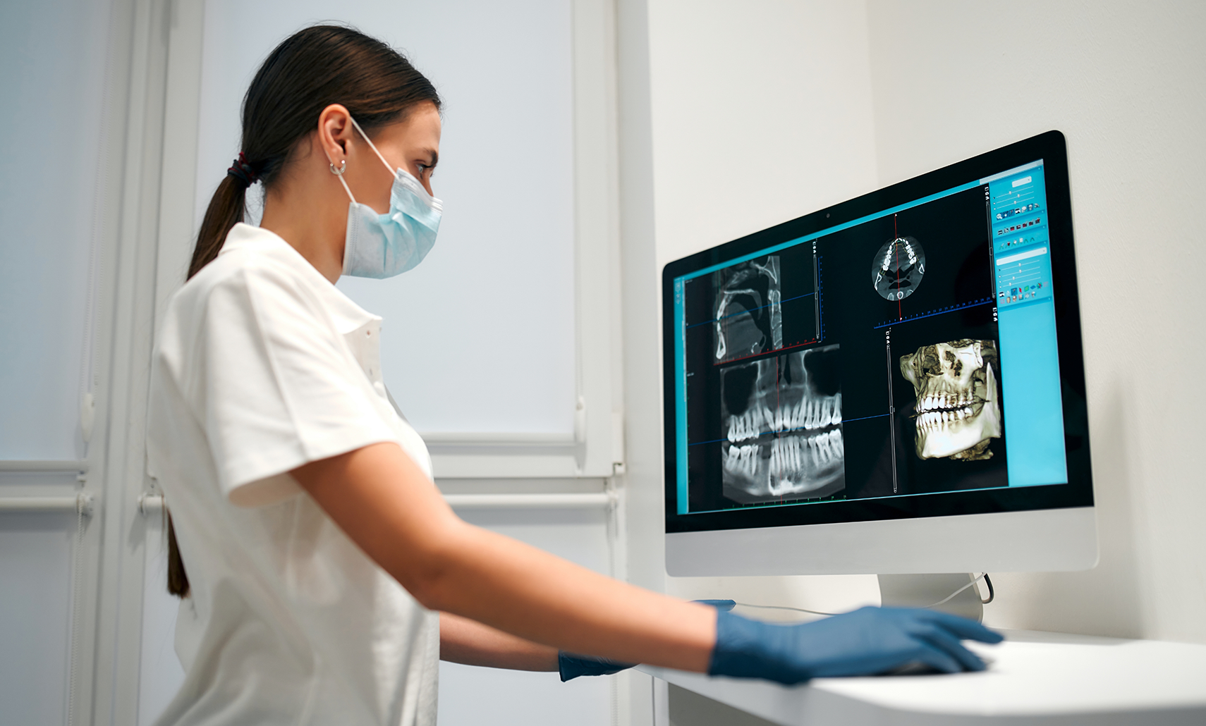 Dentist looking at digital x-rays of a patient's teeth