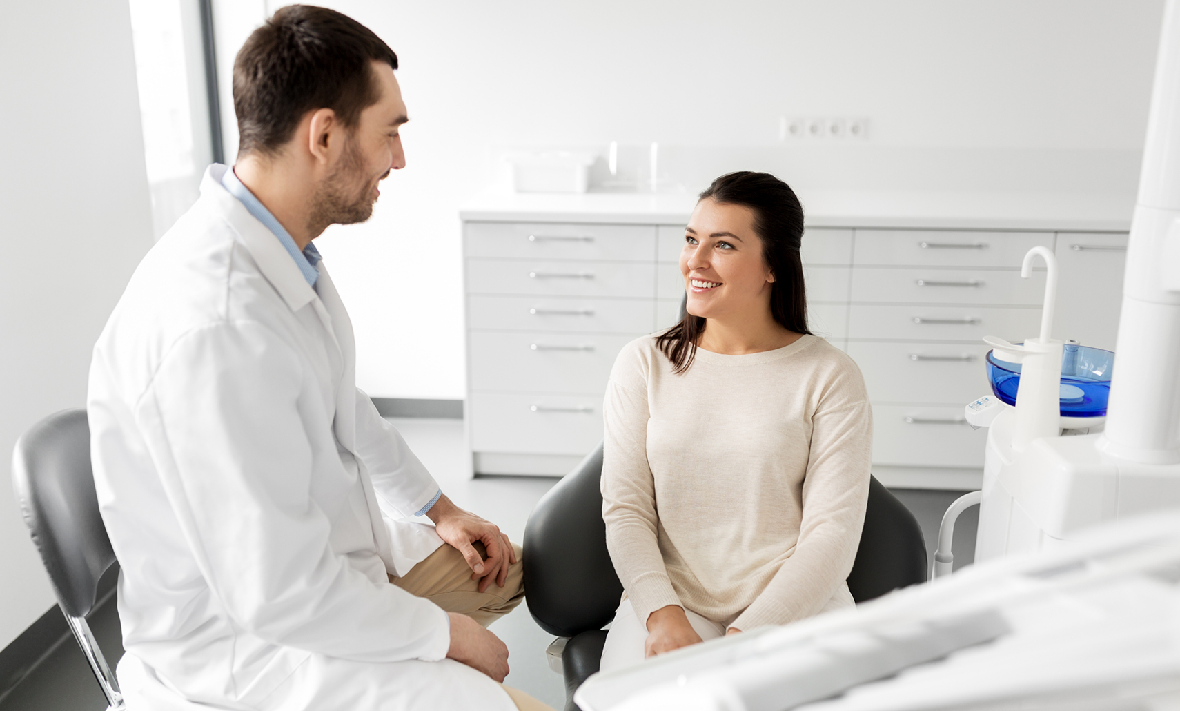 Woman smiling while talking with her Houston dentist